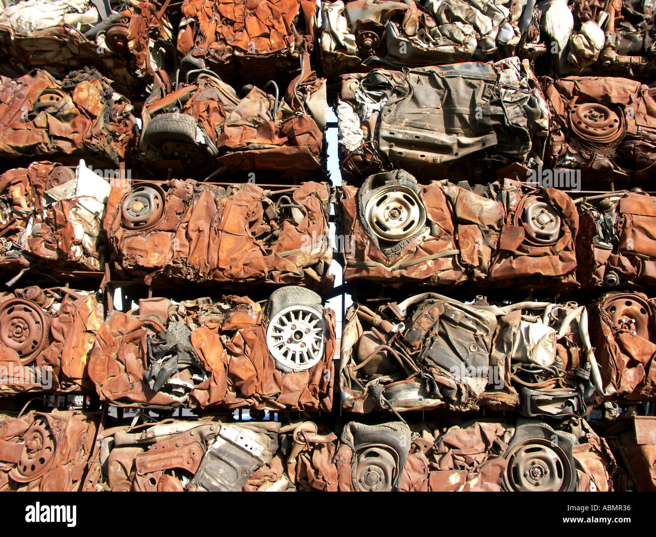 stacked crushed cars used as the wall to a car yard in birmingham
