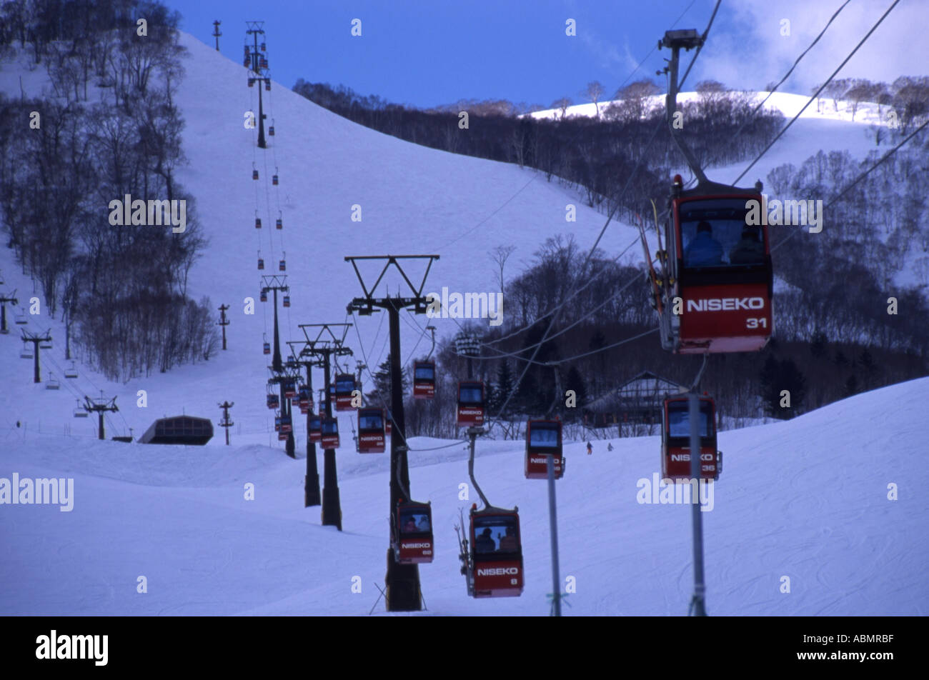 Cable cars take skiiers and boarders up the slopes of Niseko ski resort Hokkaido Japan Stock Photo
