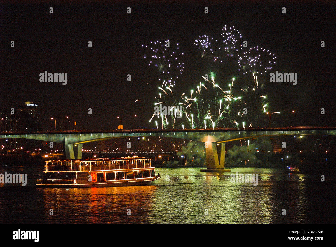 Ferry boat next to bridge over Han river during fireworks display Seoul South Korea Stock Photo