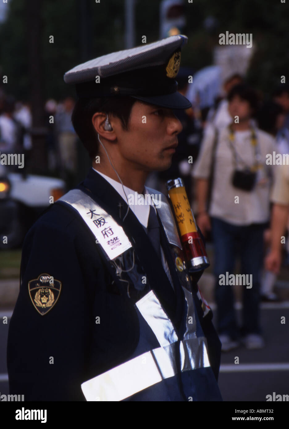 Japanese policeman watches over crowds at 2002 World Cup football soccer Stock Photo