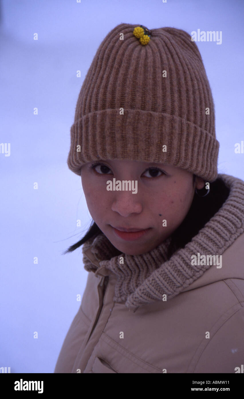 Hokkaido Girl stands in the snow Japan Stock Photo