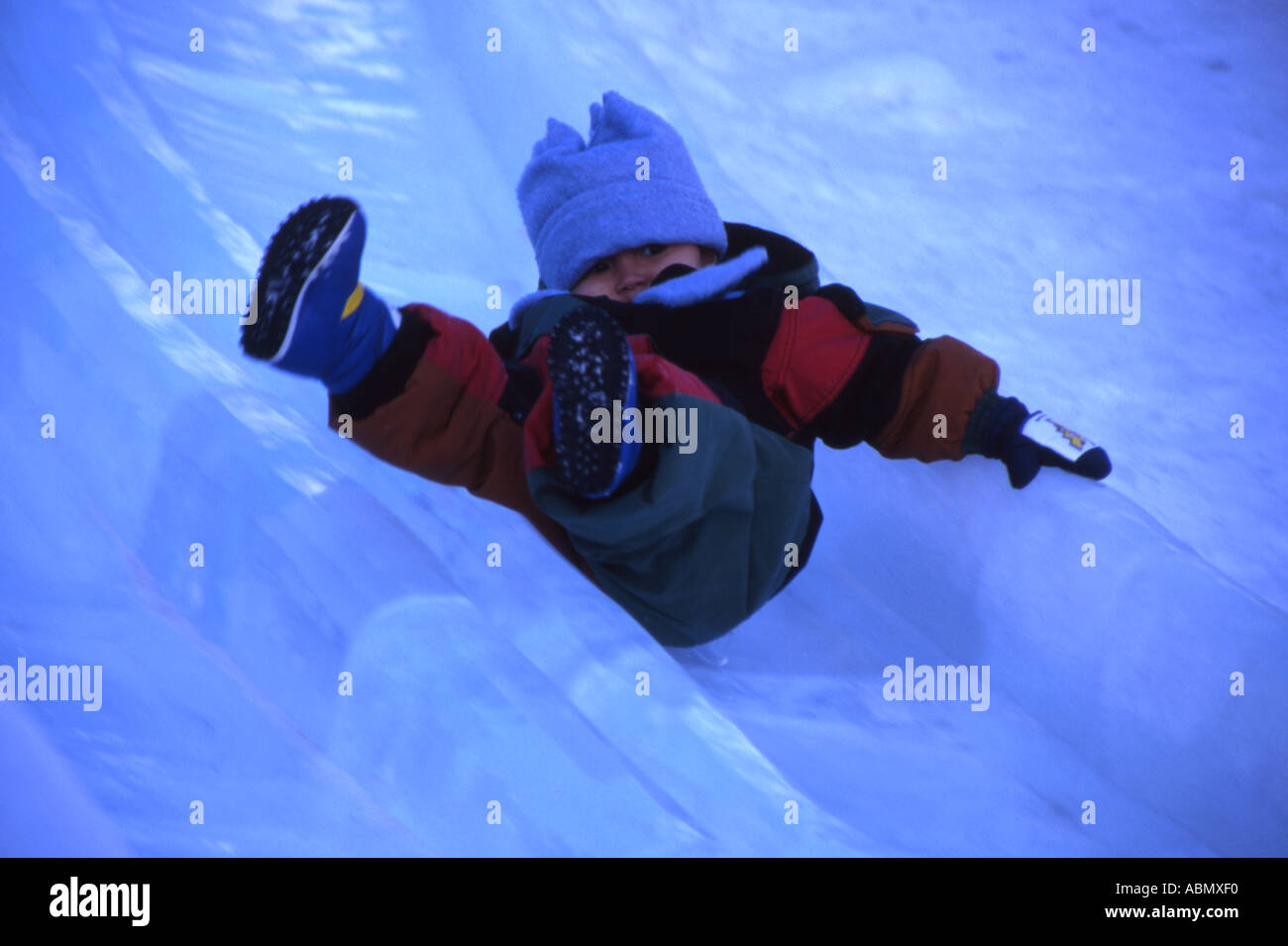 Young boy flies down ice slide at Sapporo Snow Festival Hokkaido Japan Stock Photo