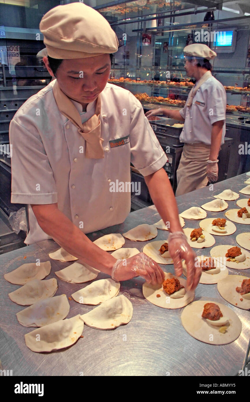 Singapore pastry chef creating filled pastries Stock Photo