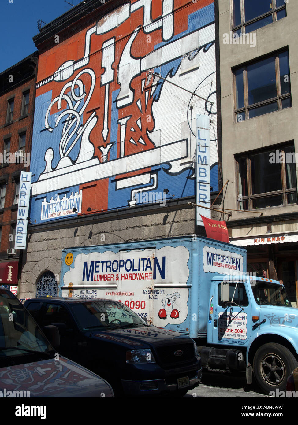 Hardware store Manhattan building front painted with mural truck Stock