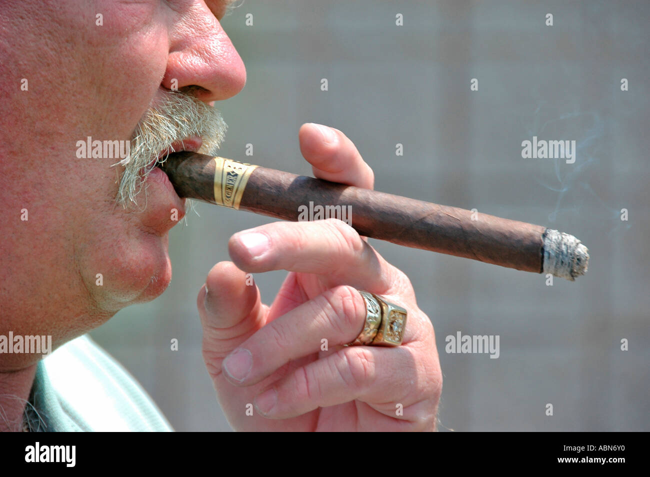 Man Smoking cigar or cigarette which cause health problems from smoke