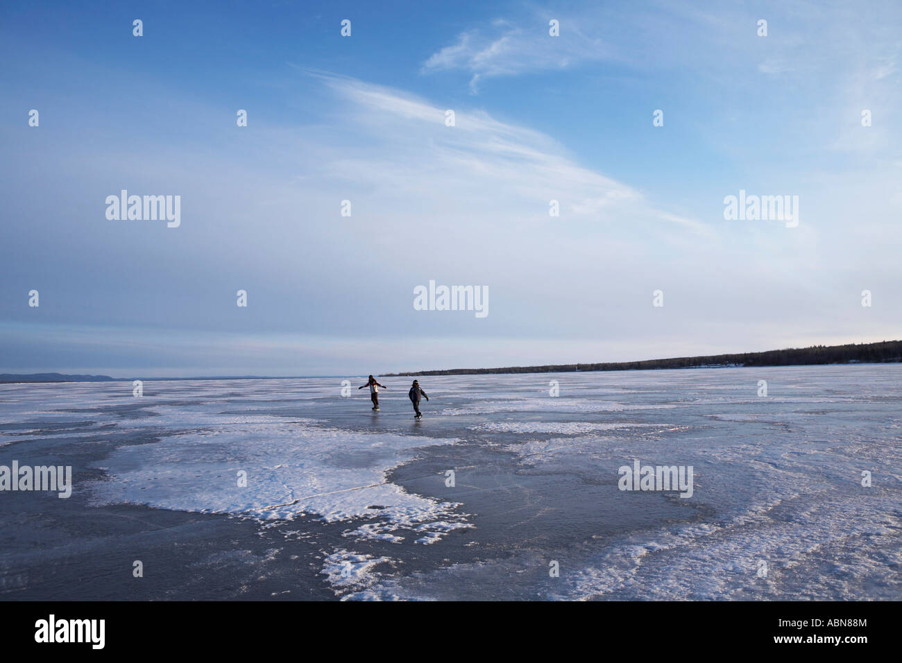 People Skating on Frozen Lake Stock Photo - Alamy