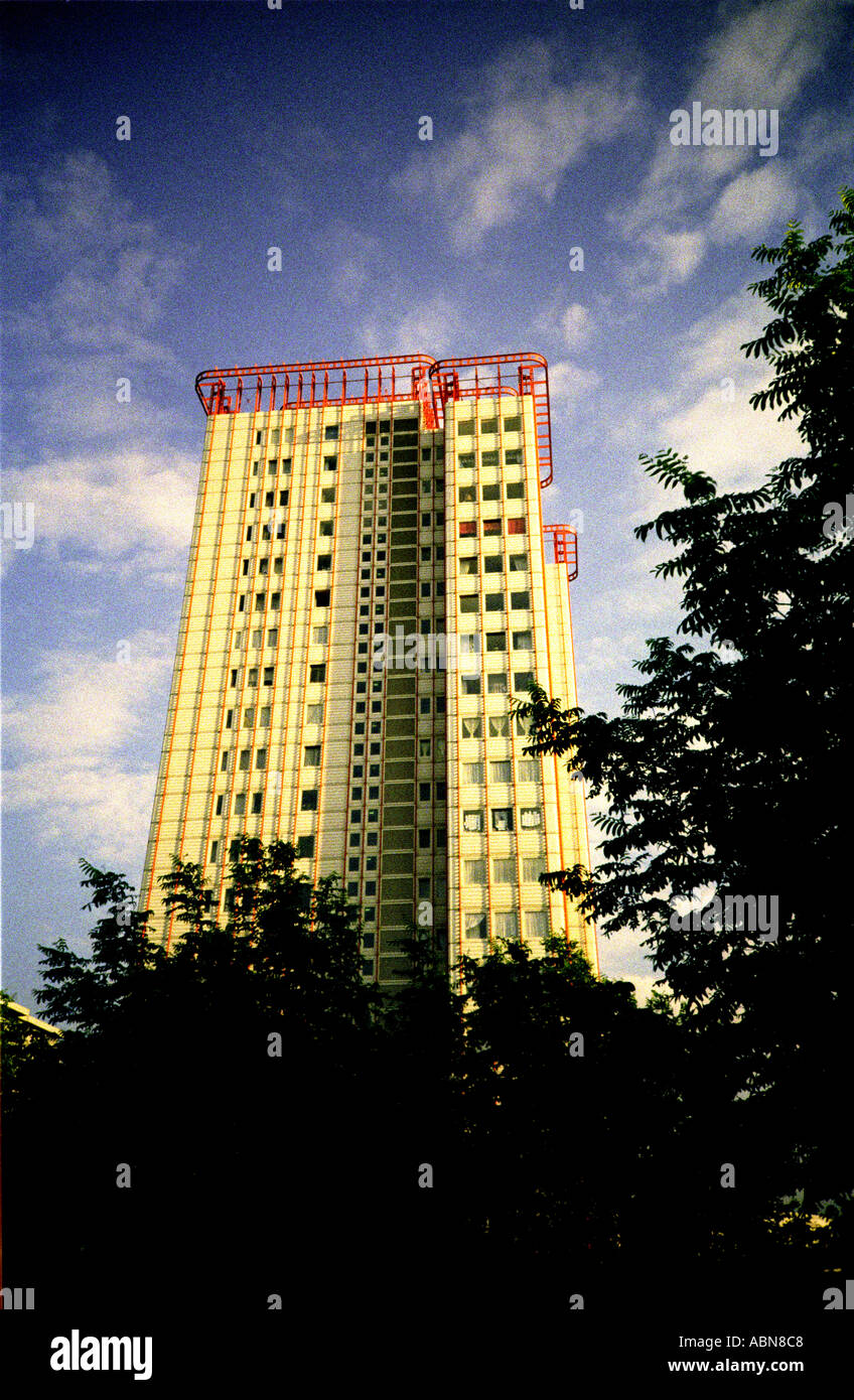 Edgware Rd tower block with red railings on top, trees,London UK Stock Photo