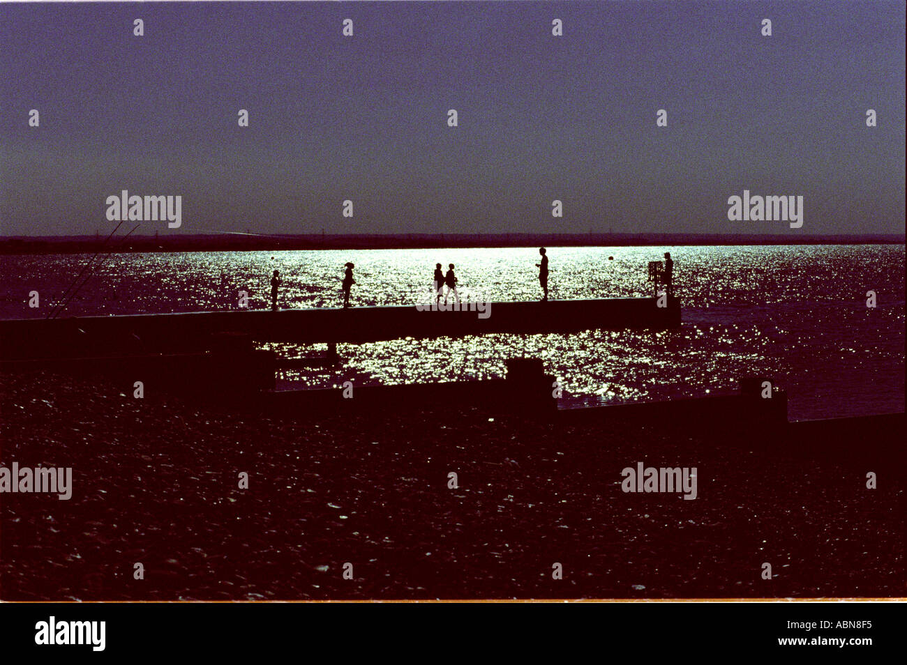 silhouettes on jetty Stock Photo