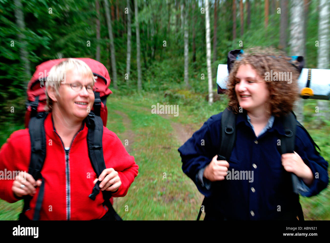 two women hiking cheerful togethter in forest MR Stock Photo - Alamy