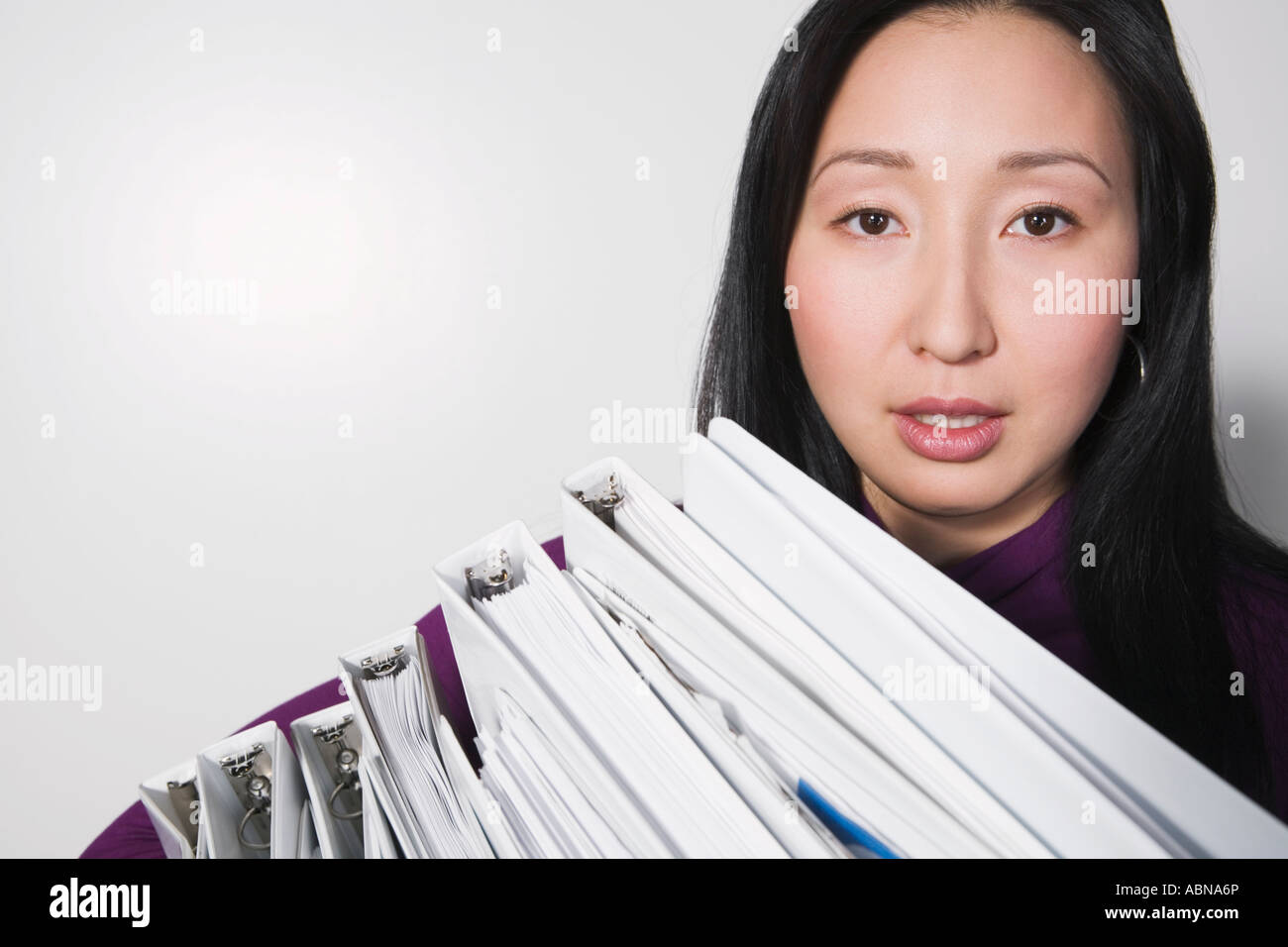 Businesswoman carrying stack of binders Stock Photo Alamy