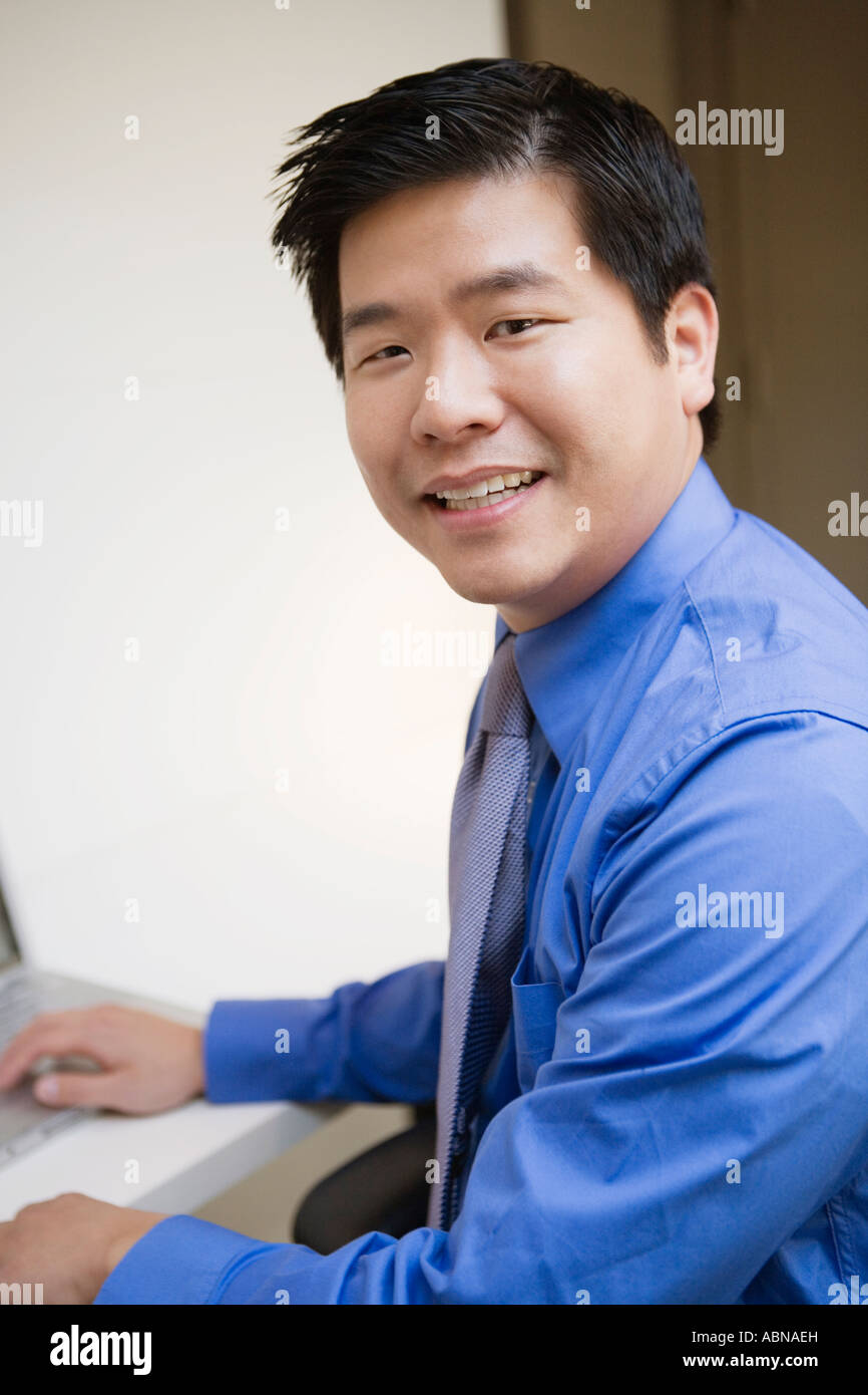 Businessman smiling at his desk Stock Photo Alamy