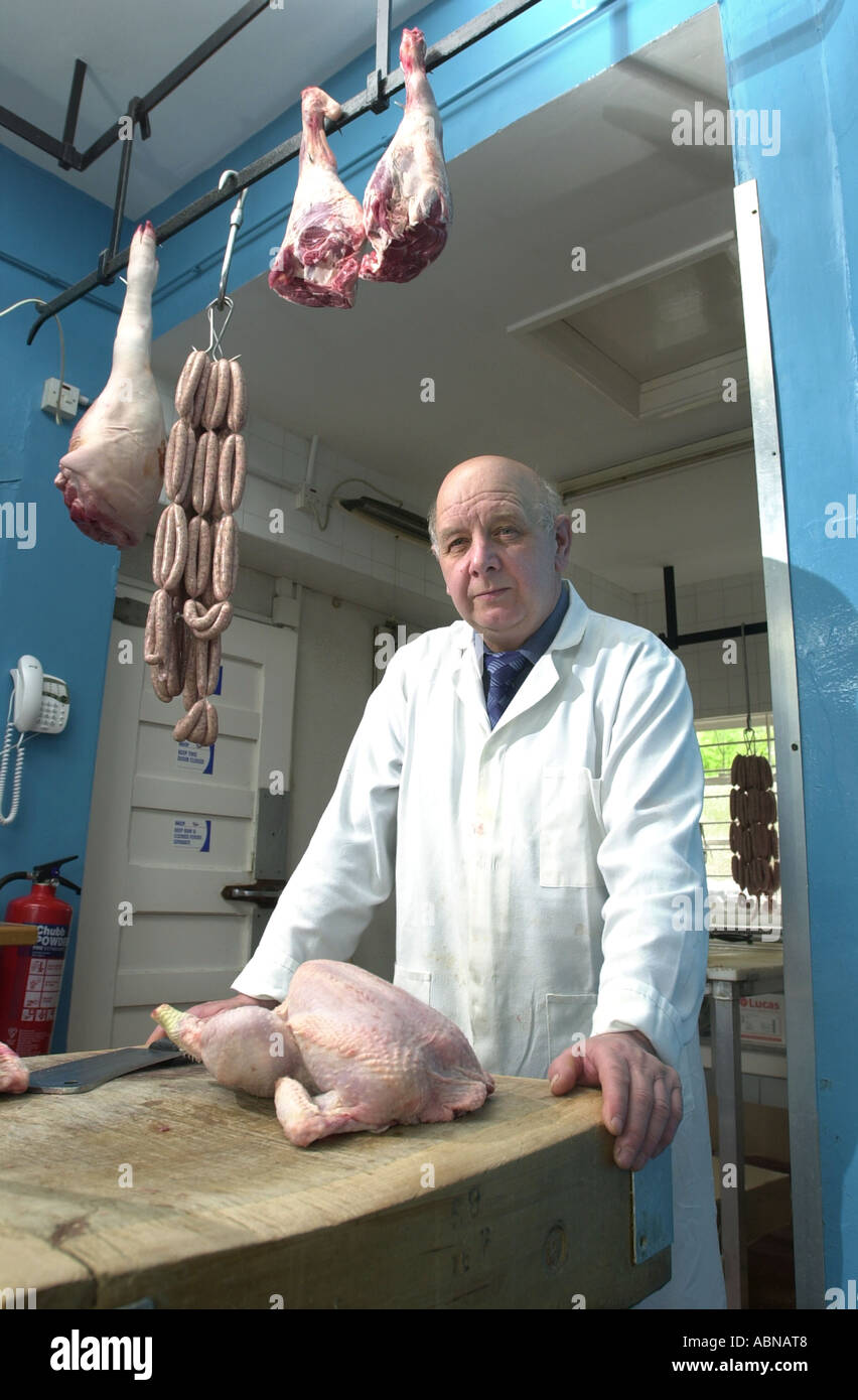 Butcher sands in his shop UK Stock Photo