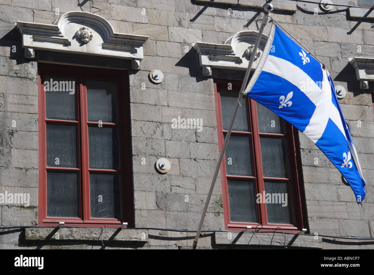 The flag of Quebec flying in the old town of Montreal in Canada Stock Photo