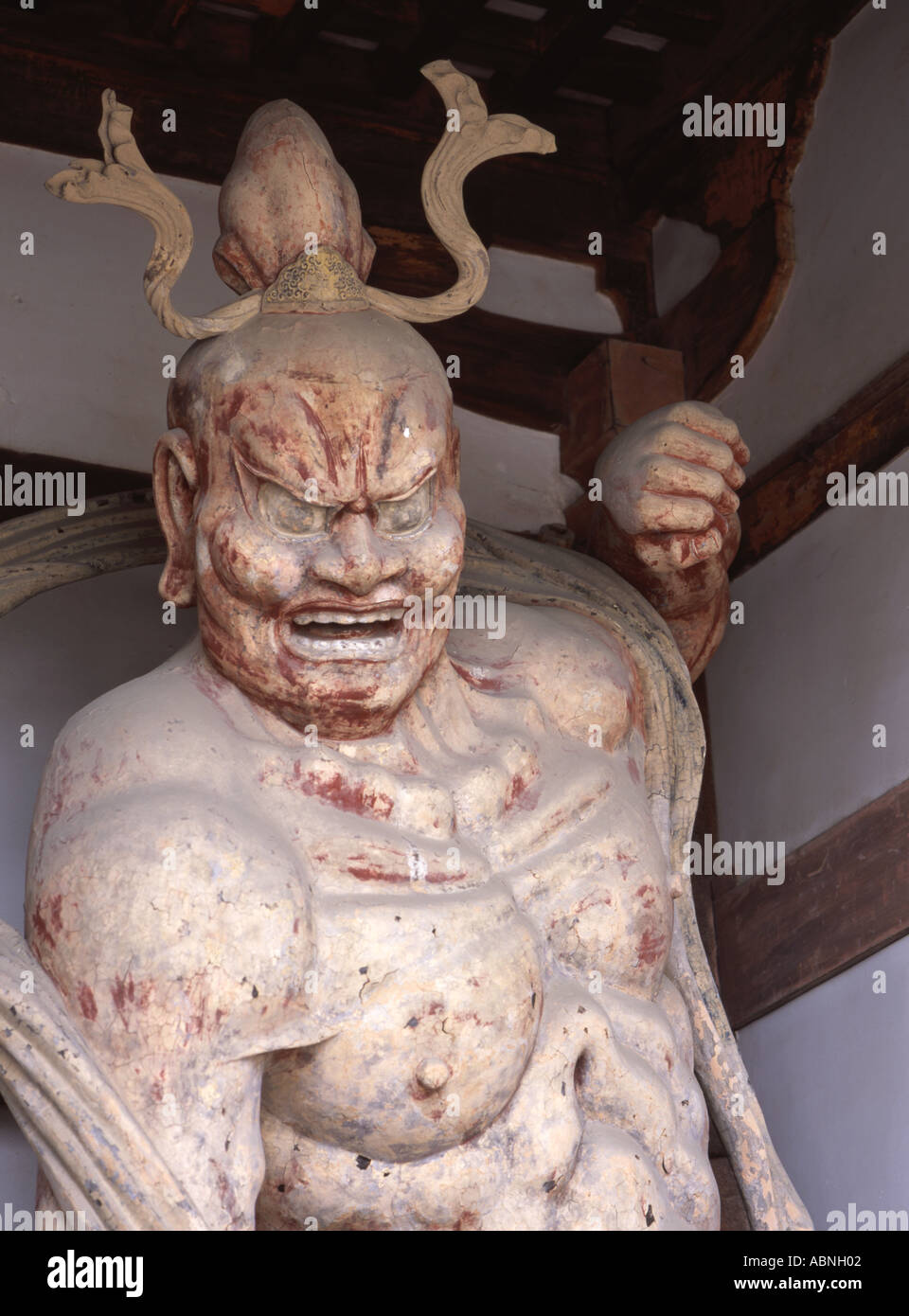 A fierce heavenly guardian stands at Horyuji temple near Nara Japan