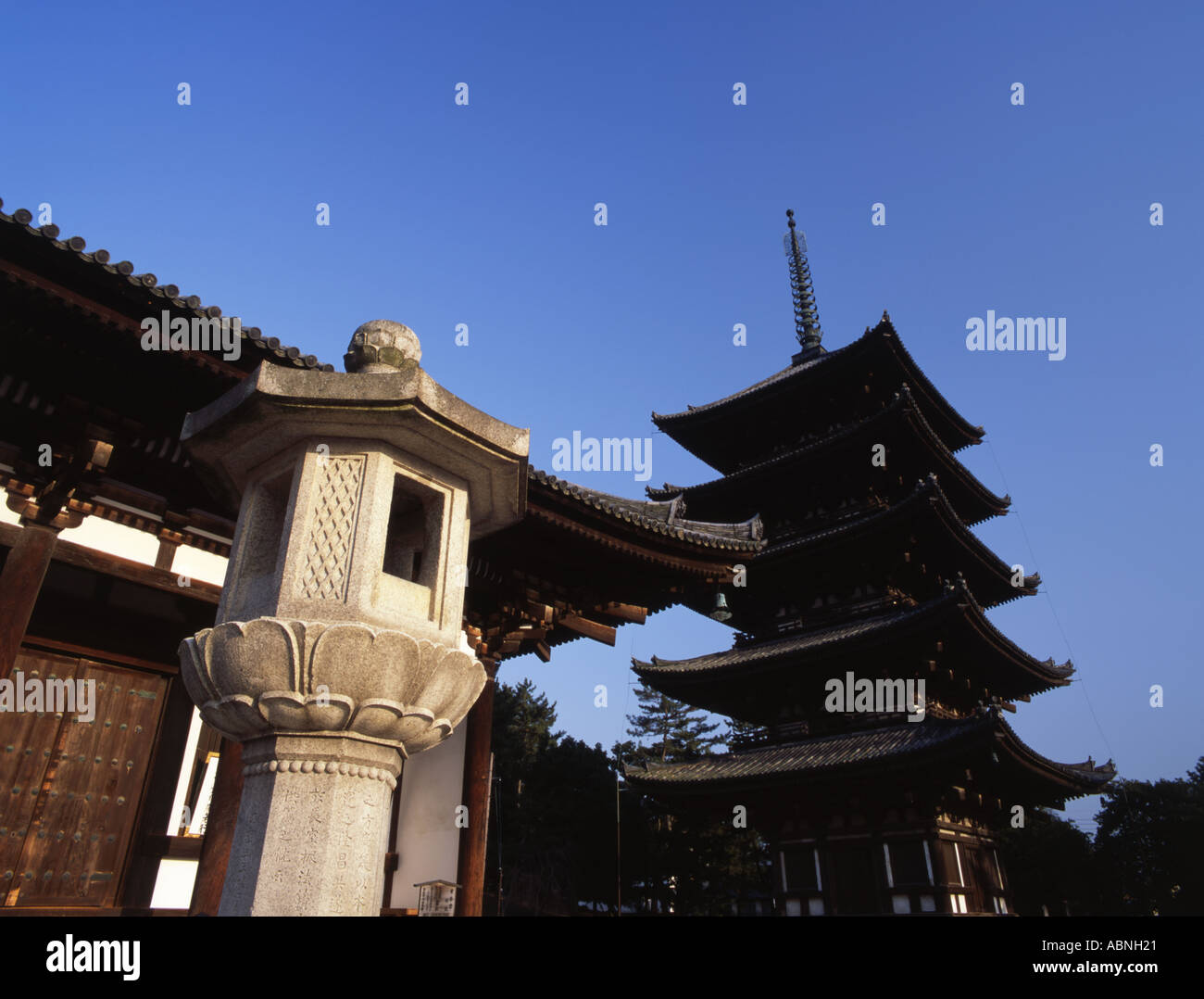 A stone lantern and the five story pagoda at Kofukuji temple Nara Japan Stock Photo