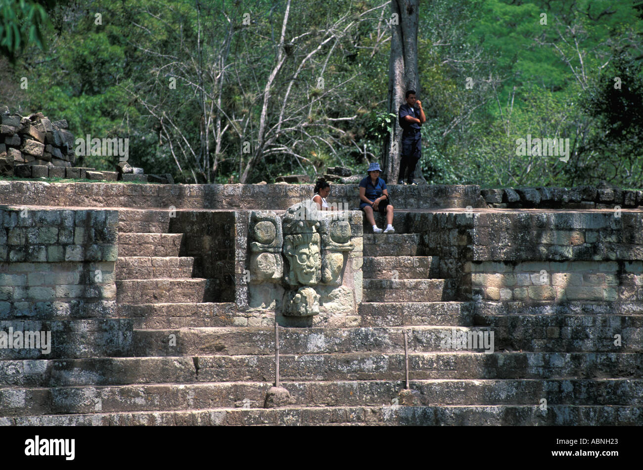 Honduras Copan Ruinas Maya ruins Mayan architecture tourists at the sculpture of the Venus God horizontal tourism travel Stock Photo