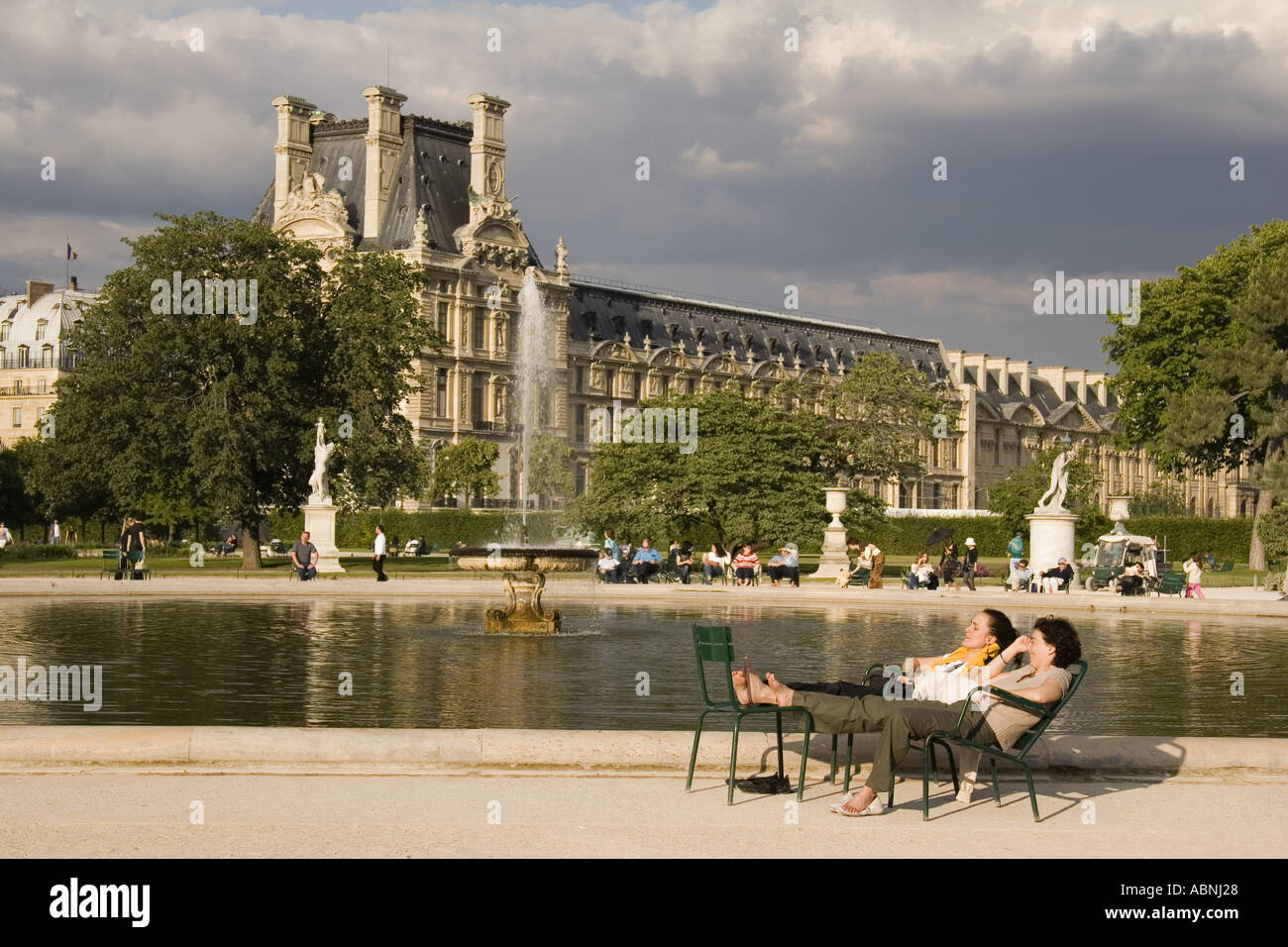 Fountain at Jardin des Tuileries sculpture garden with the Musee du Louvre in back Paris France Stock Photo