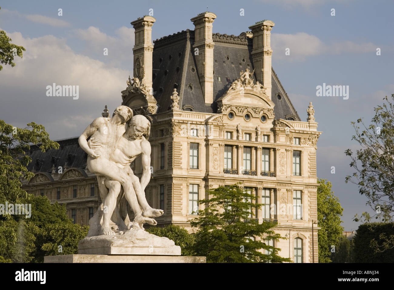 Statues in the Jardin des Tuileries sculpture garden with the Musee du Louvre in back Paris France Stock Photo