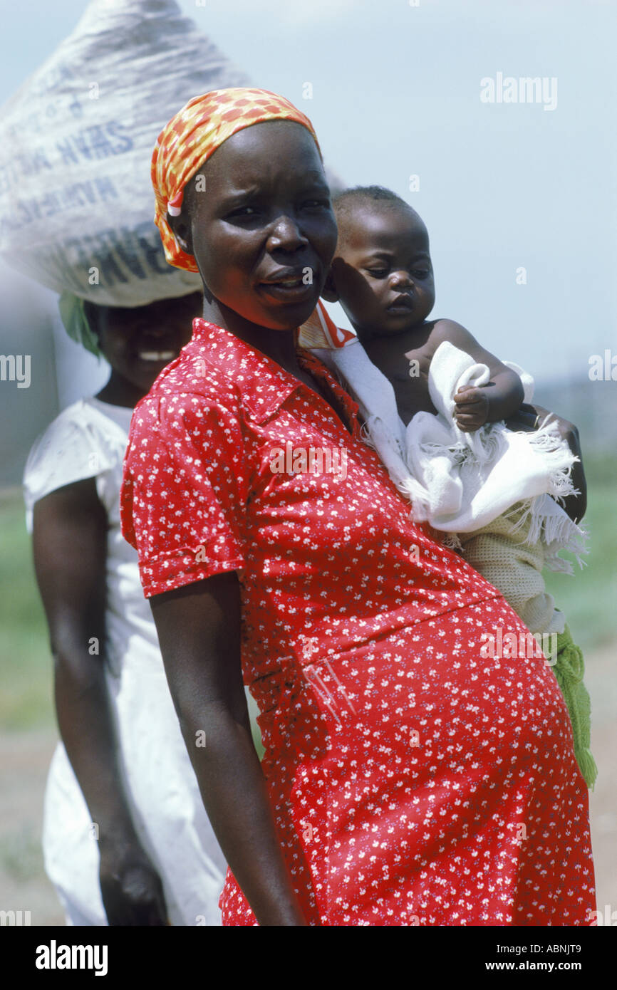 Pregnant African woman with one baby in the arm and one in the womb Stock Photo