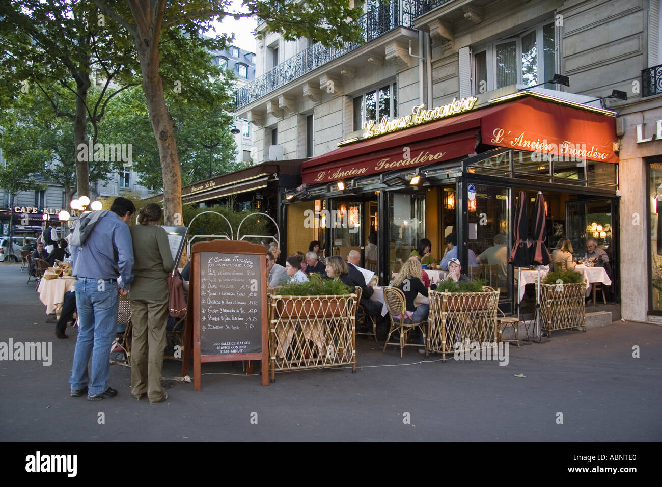 Couple looks at menue at L Ancien Trocadero restaurant at Place du Trocadero Paris France Stock Photo