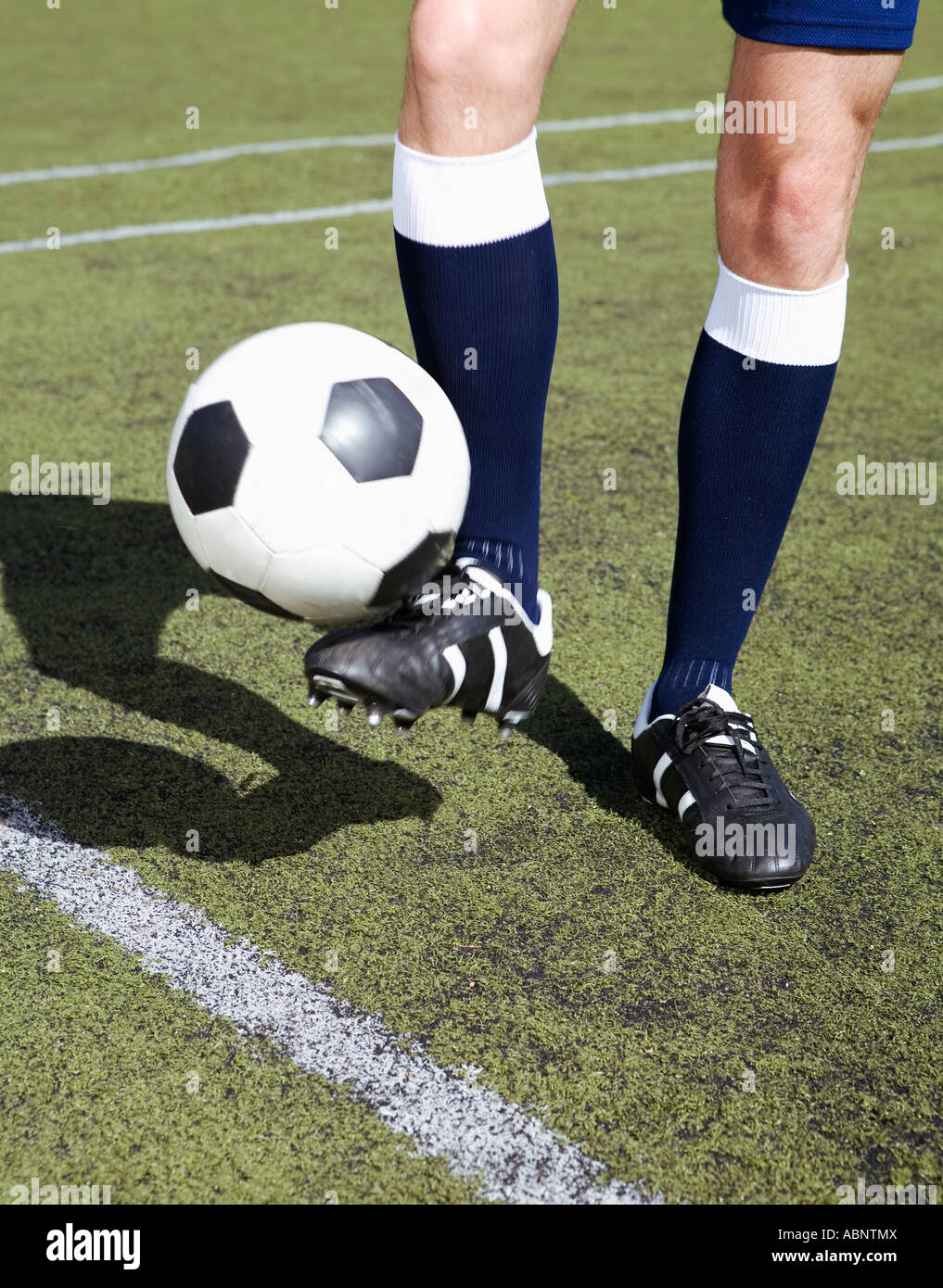 Soccer player bouncing the ball with his foot Stock Photo Alamy