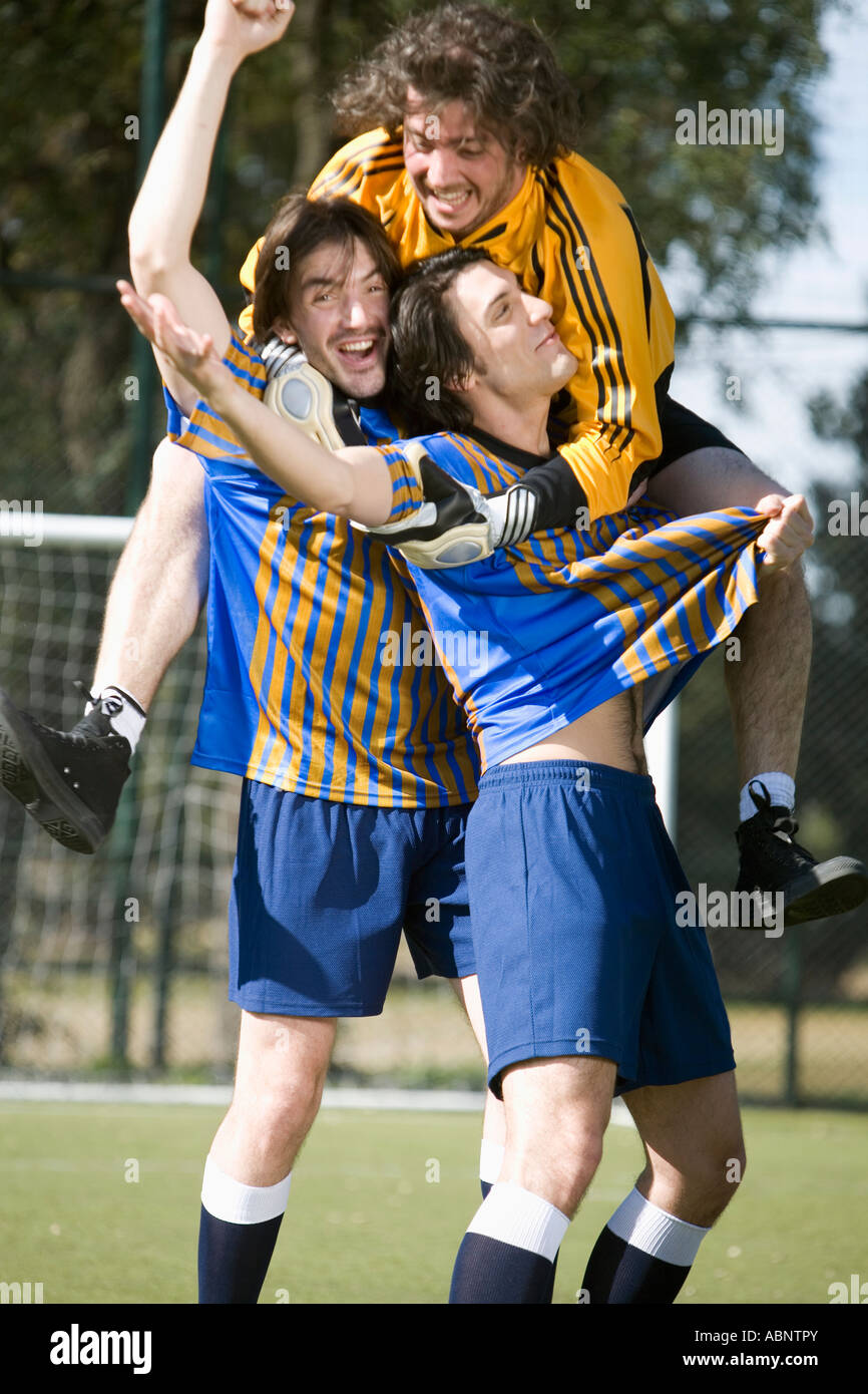 Male soccer players celebrating on field Stock Photo