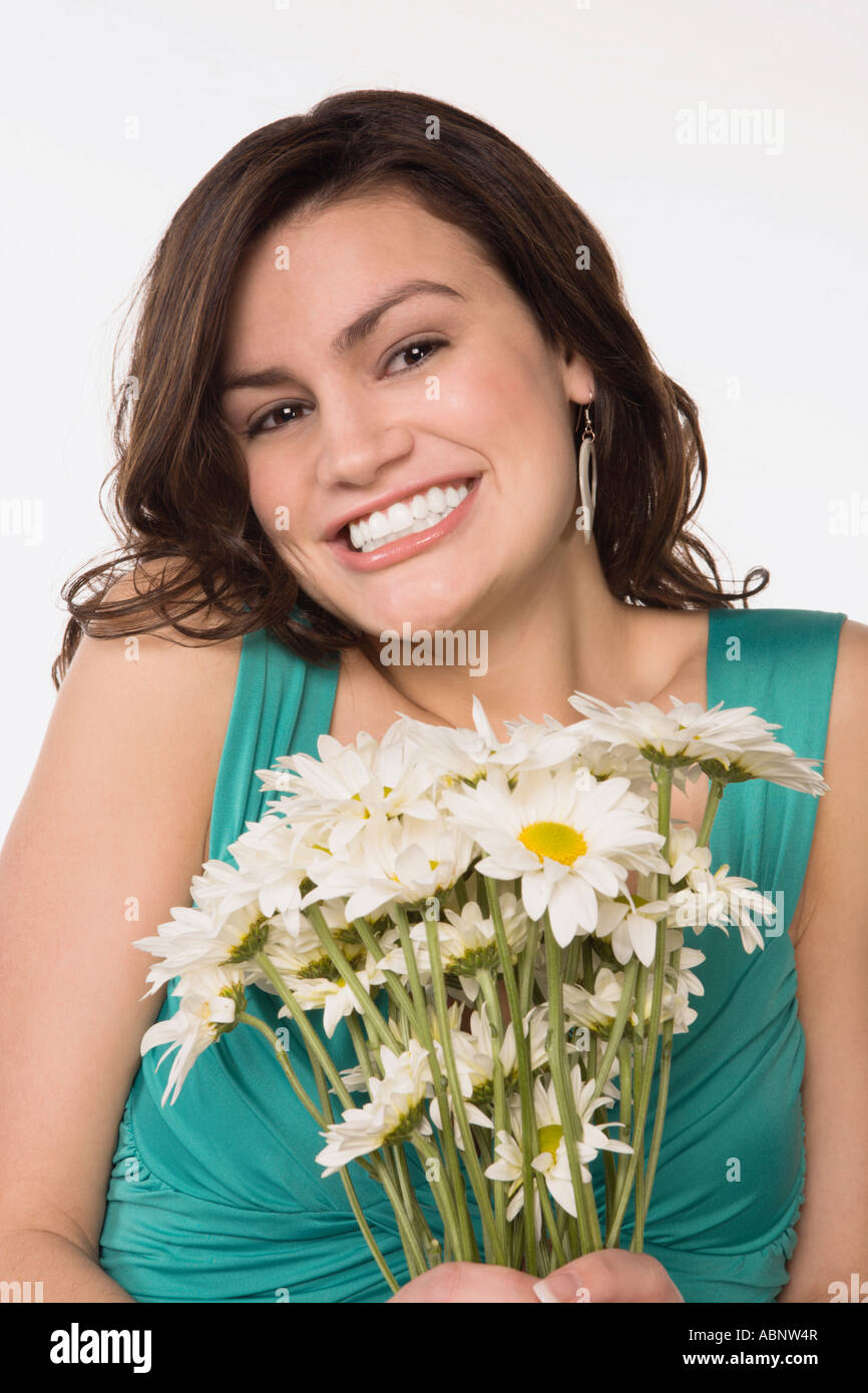 Teenage girl holding bouquet of flowers Stock Photo - Alamy