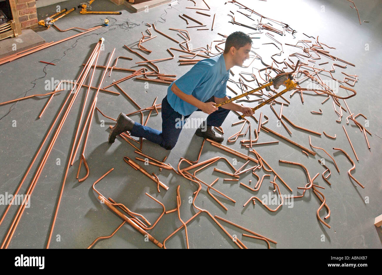 A young apprentice Gas Service Engineer practicing his skills with