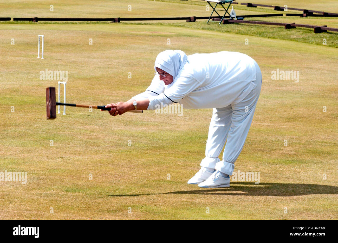 Egyptian lady croquet champion playing in Sussex in headscarf Stock
