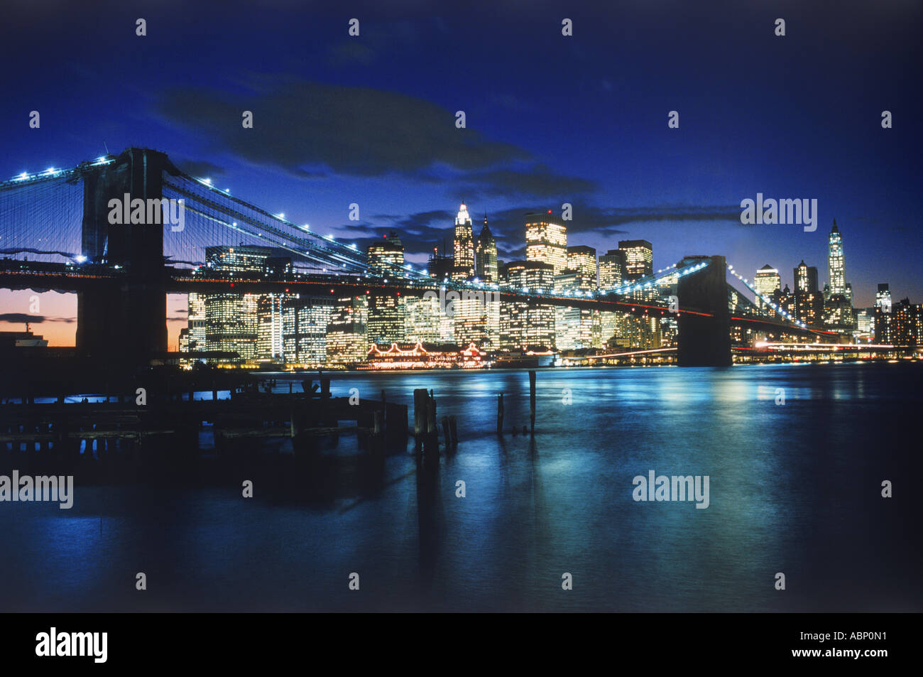 Brooklyn Bridge over East River with New York City skyline at night ...