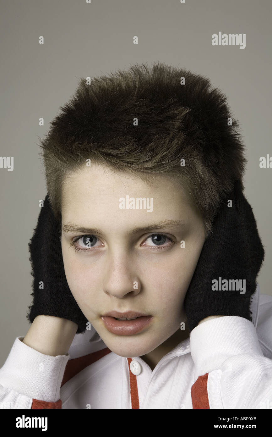 English boy covers ears Stock Photo