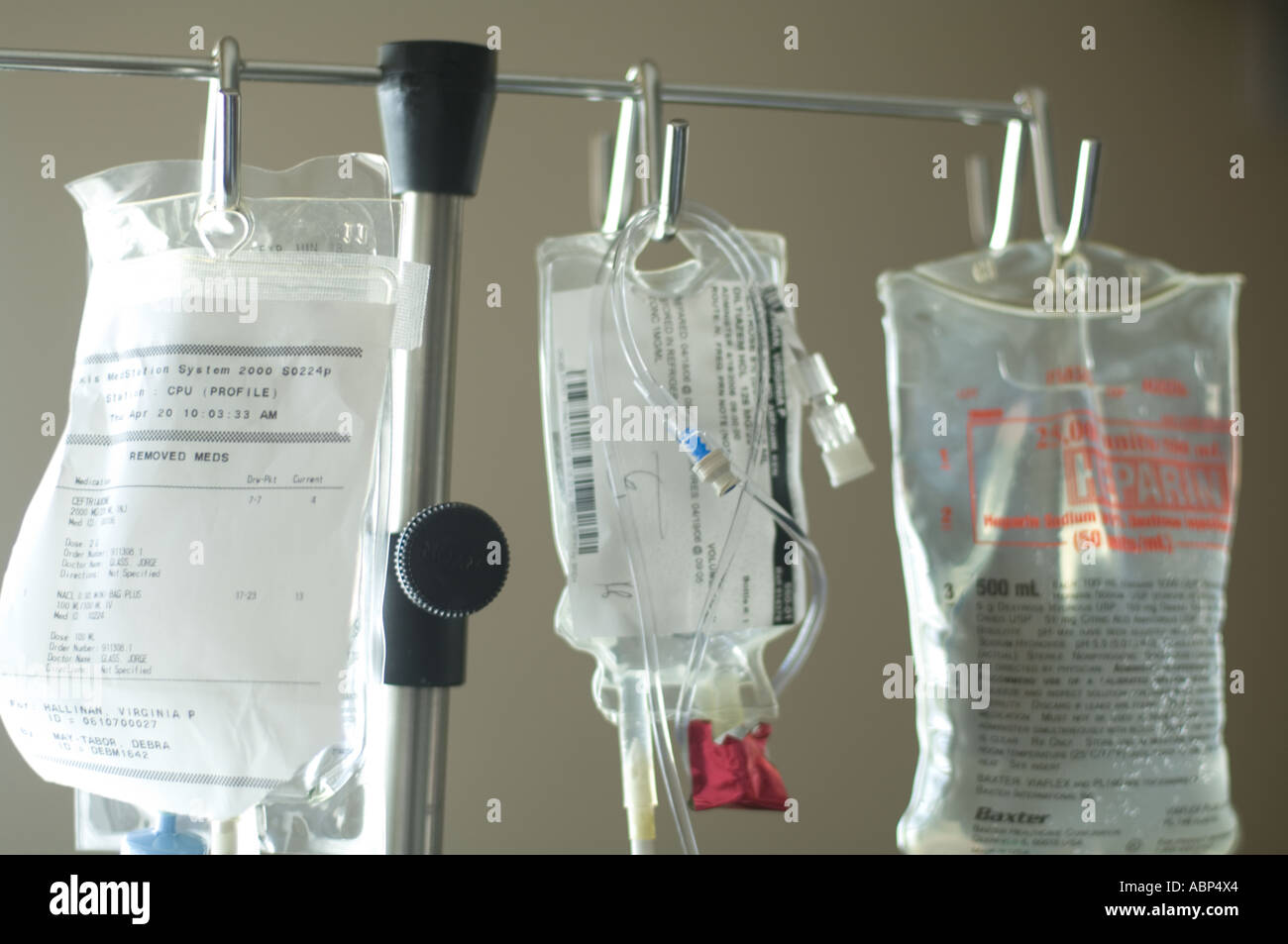 rack of IV intravenous bags hanging in hospital intensive care ward for
