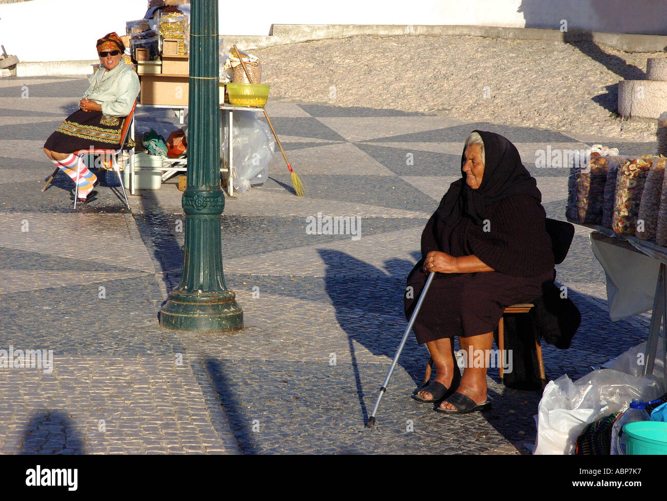 Portrait of old ladies in colourful & black traditional clothing selling nuts dry fruit Nazare Sitio Costa Prata Portugal Europe Stock Photo