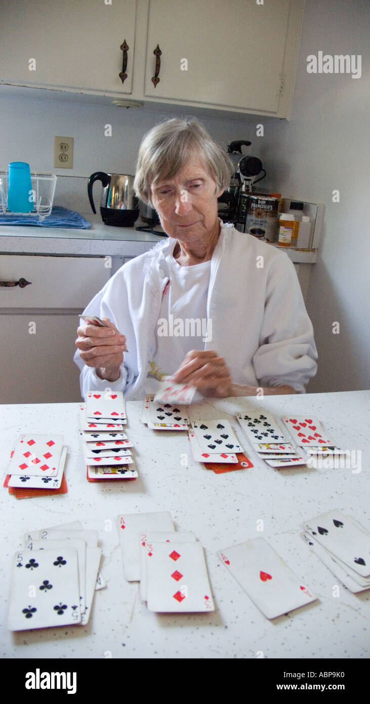 Old Woman Playing Card Game Of Solitaire Alone In Kitchen Stock Photo Alamy