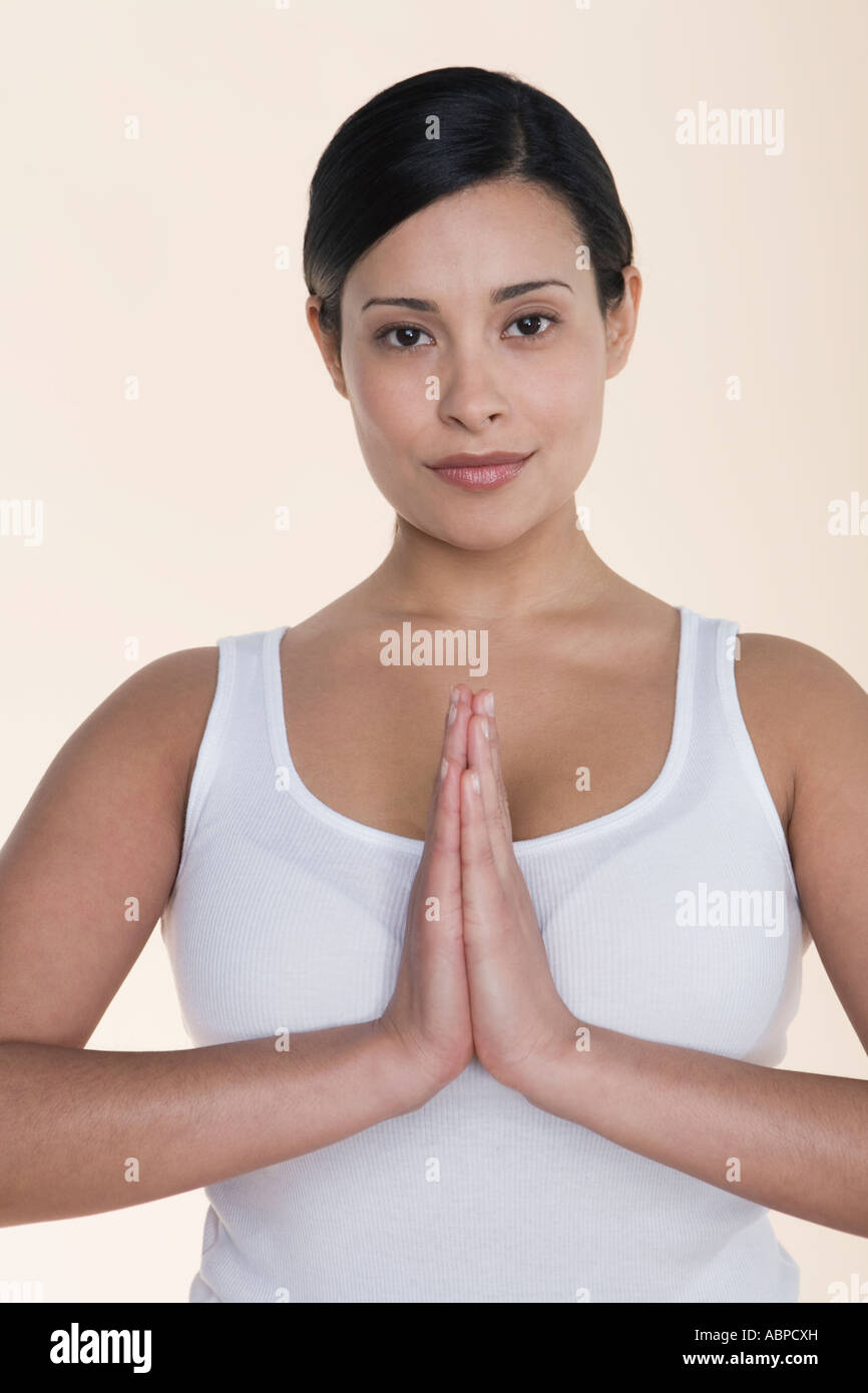 Woman holding hands in praying gesture Stock Photo - Alamy