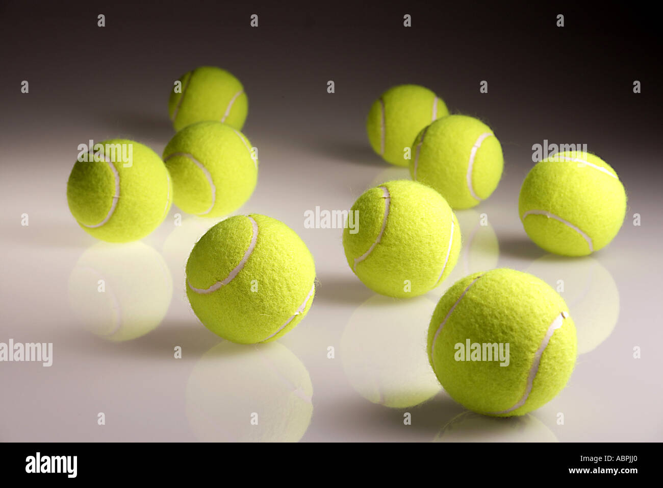 Tennis balls round circular nine green color colour made of rubber bounce bouncy reflection horizontal doublespread studio Stock Photo