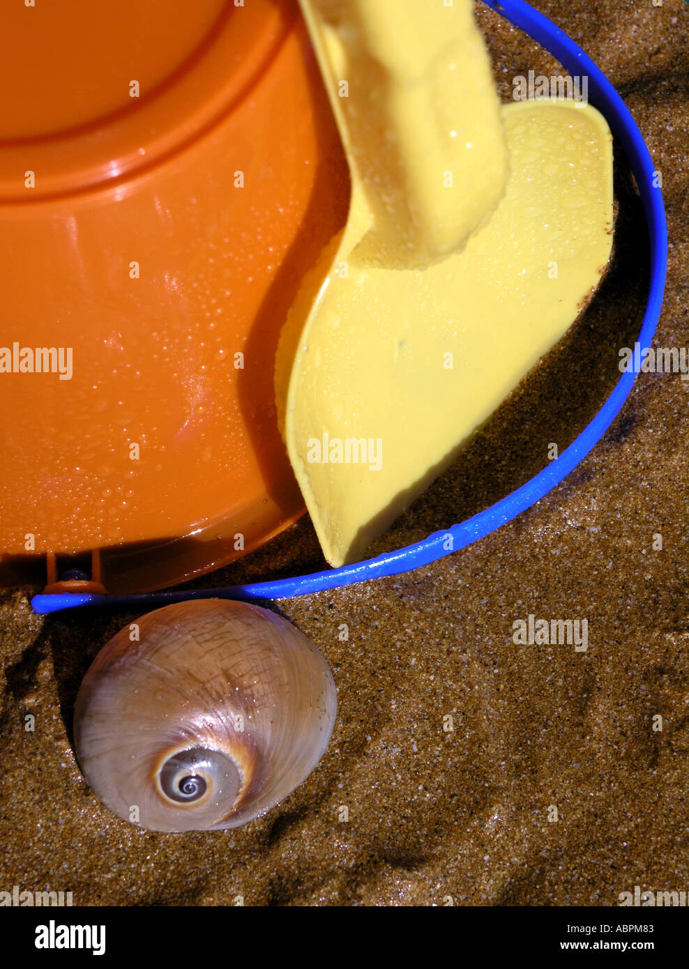 bucket spade sea shell sand on a beach Stock Photo