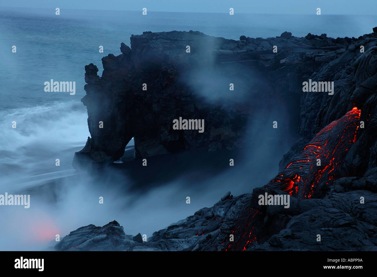Kamoamoa ocean entry Strong winds blow the steam plume along the oceans surface at sunrise Hawaii Volcanoes National Park Stock Photo