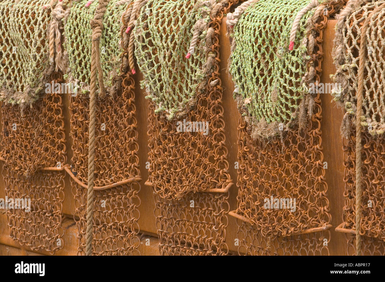 scallop dredging nets on the side of a trawler in Kirkudbright harbour Stock Photo