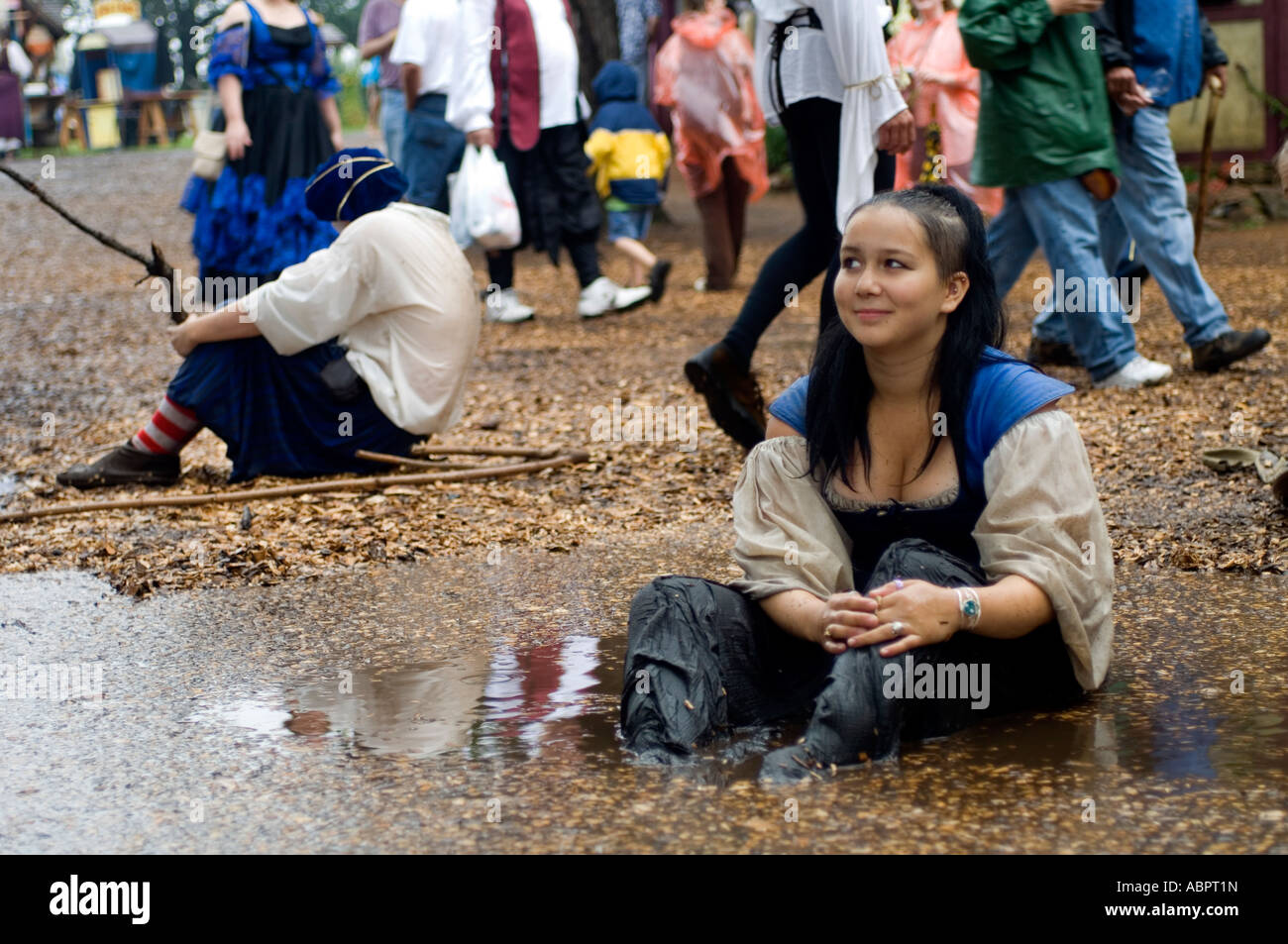 A girl sitting in a muddy puddle at the Minnesota Renaissance Festival  Stock Photo - Alamy