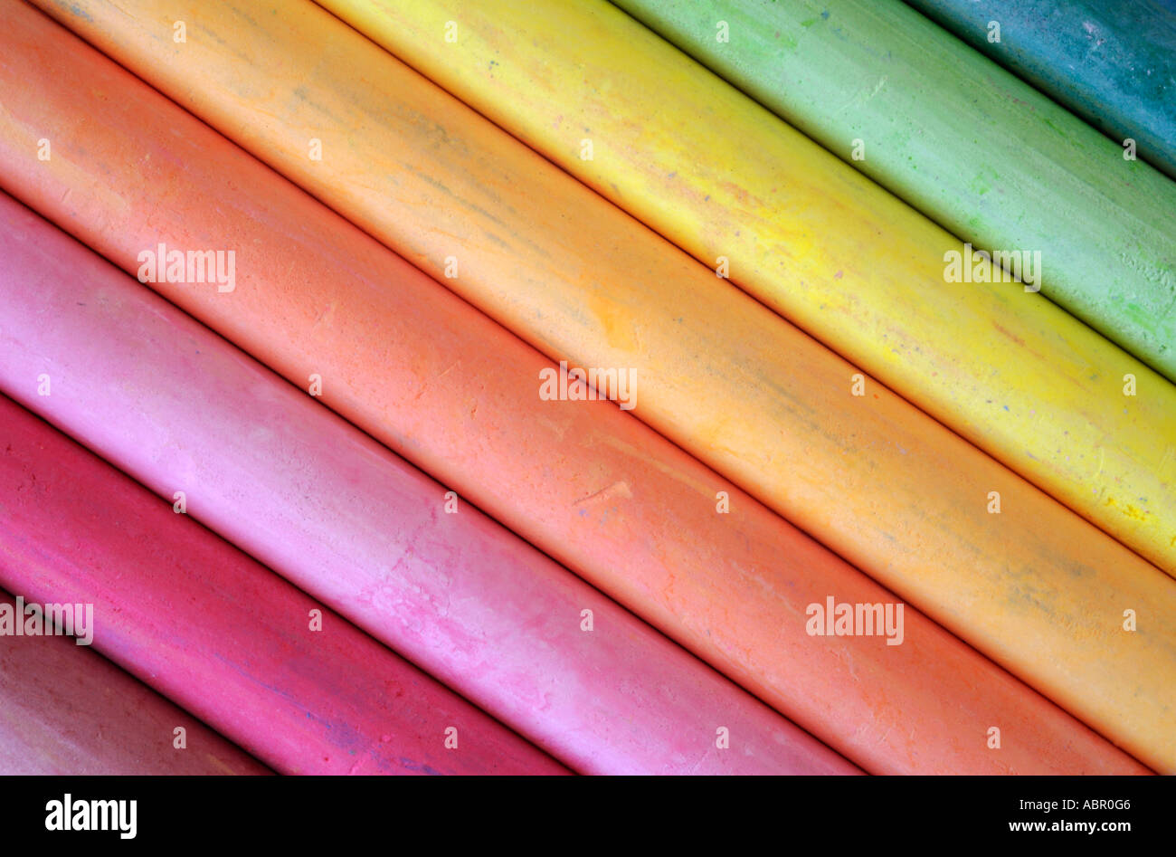 A close up photograph of a box of colorful used chalk pastels