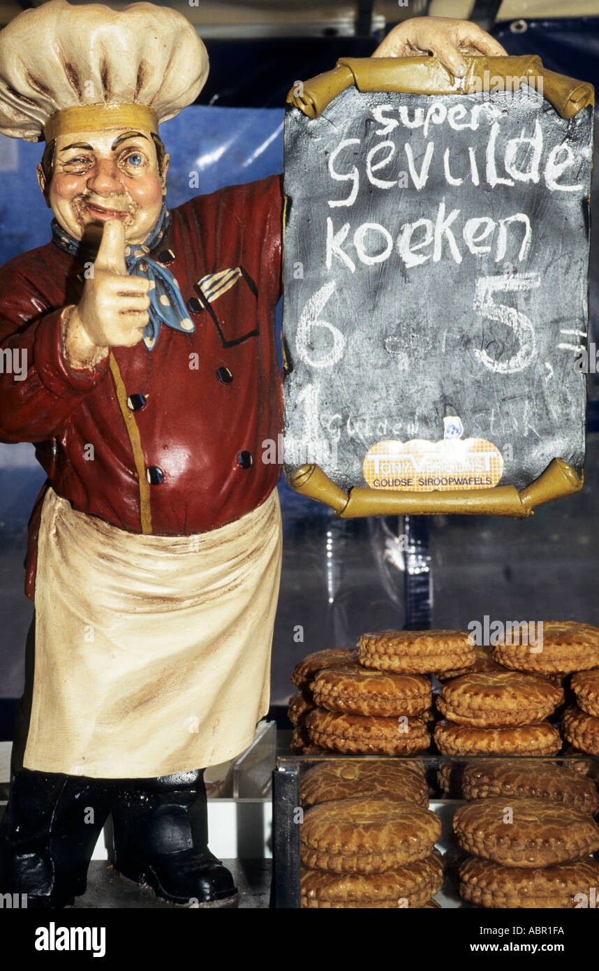 Delft, Holland. Fat baker model winking and with thumbs up to sell Gevulde Koeken cakes. Stock Photo