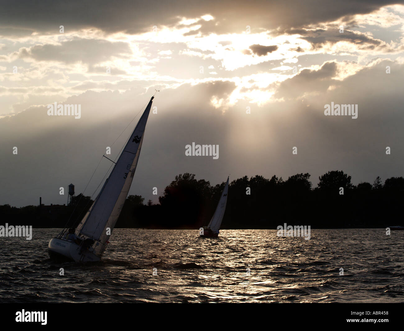 Sailboats at sunset Stock Photo - Alamy