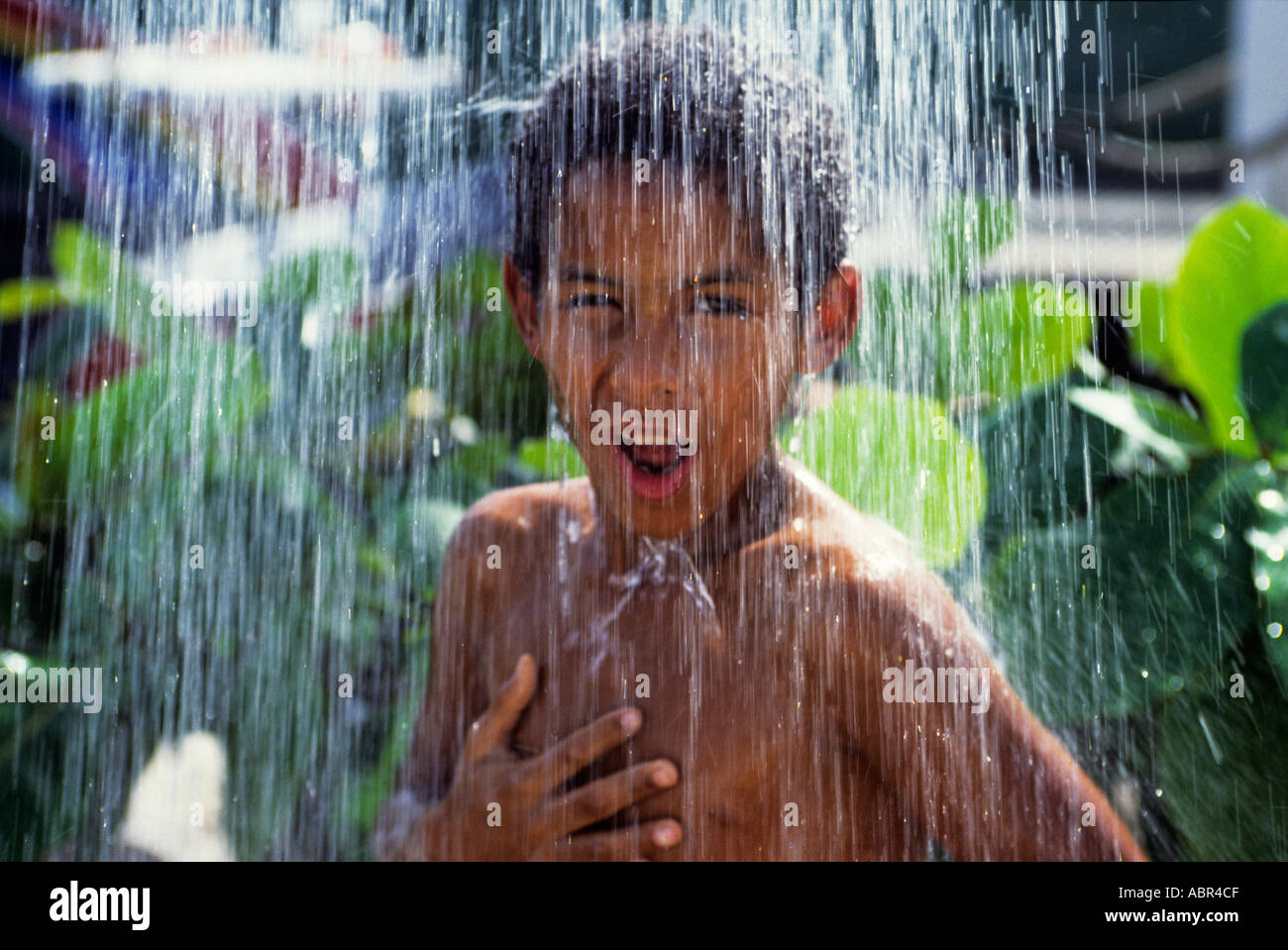 Boy taking shower in air hires stock photography and images Alamy