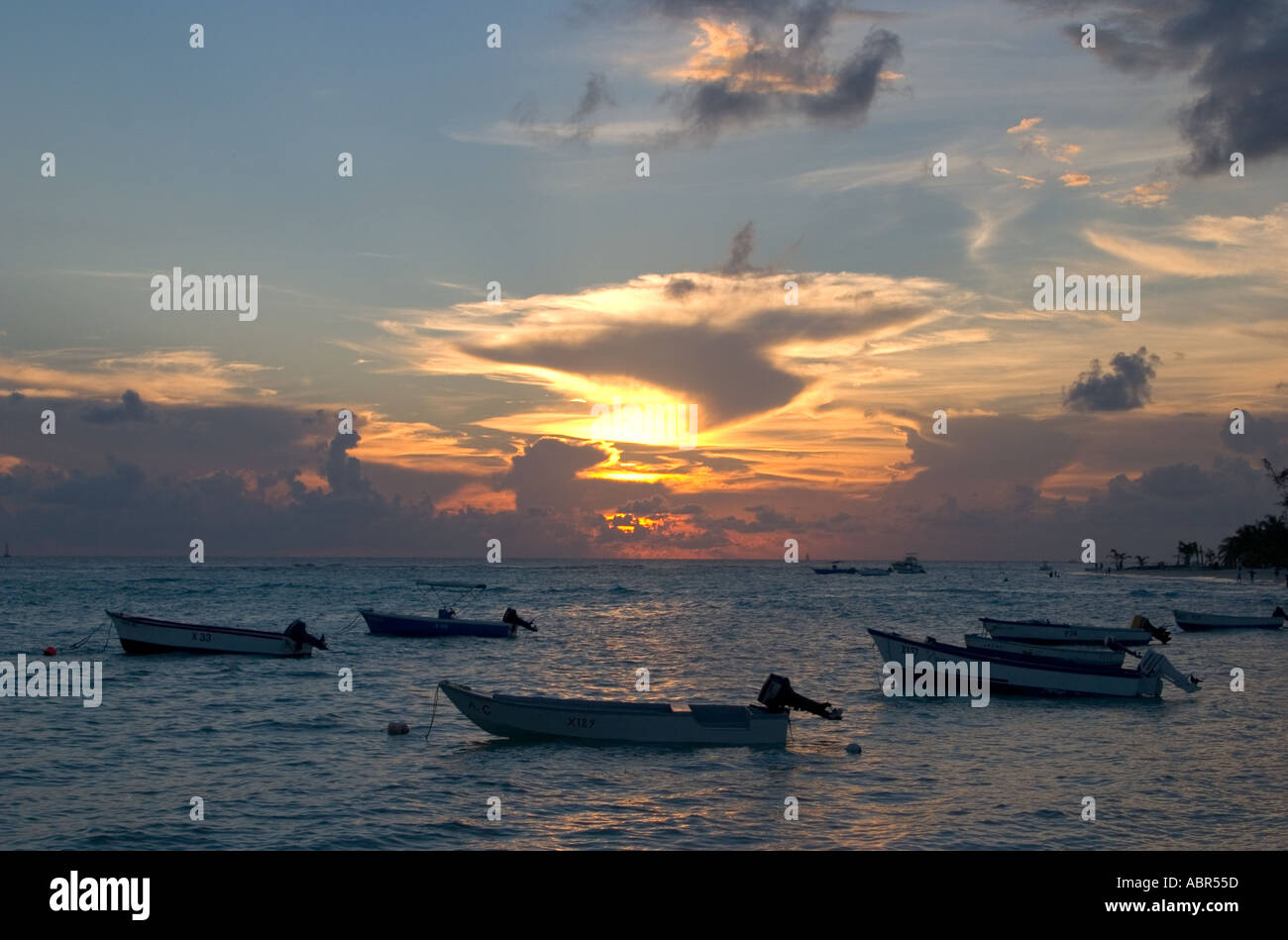 Boats at Sunset on Worthing Beach Barbados Stock Photo