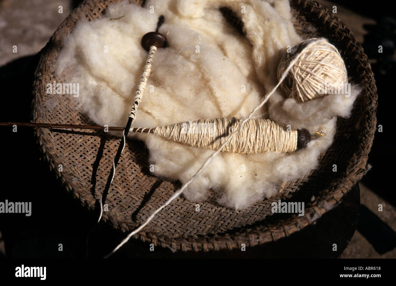 Koatinemo village, Brazil. Cotton thread with raw cotton and a spinning spindle in a basket. Stock Photo