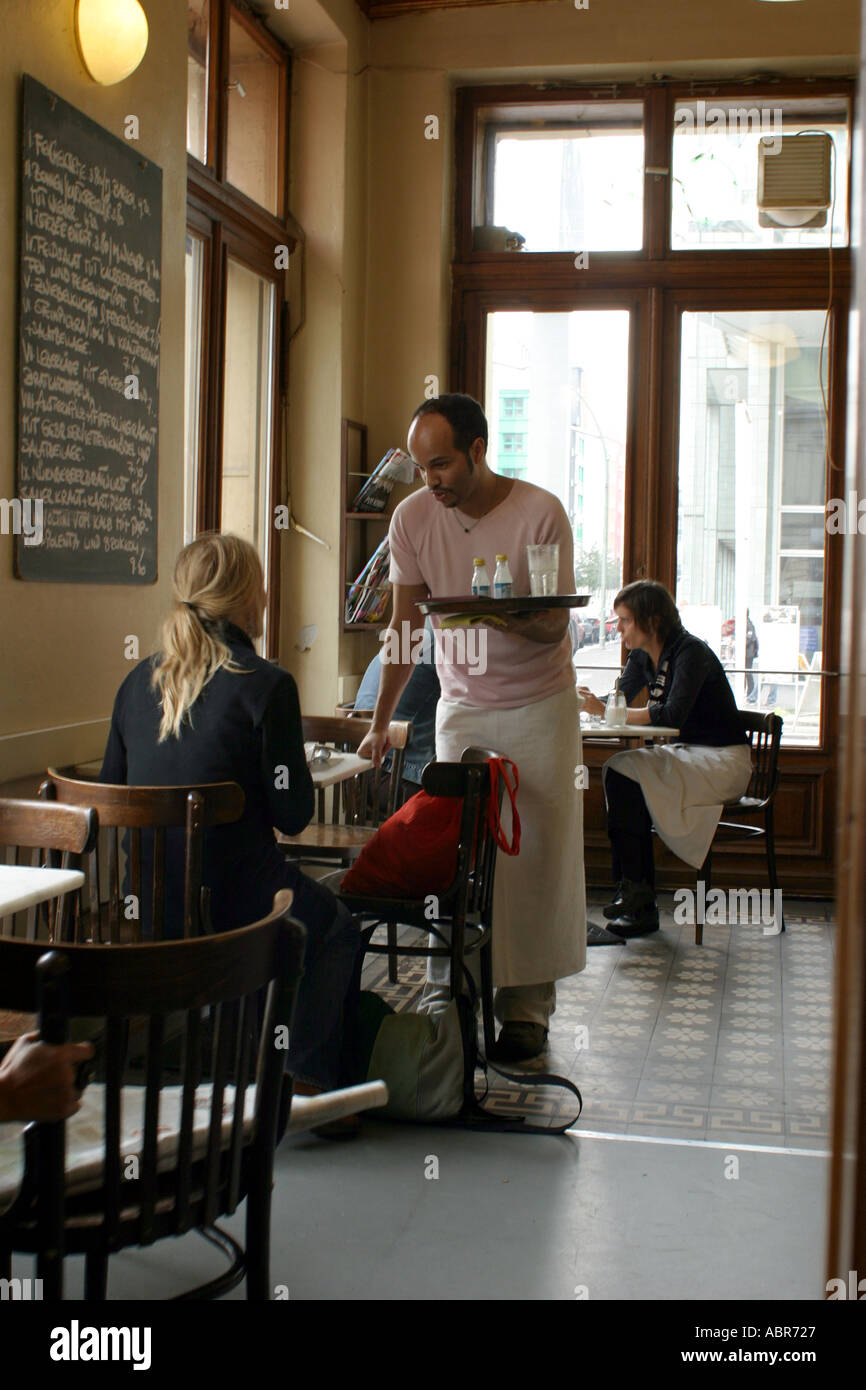 Checkpoint Charlie Inside the Cafe Adler Friedrichstr Waiter serving a customer Stock Photo