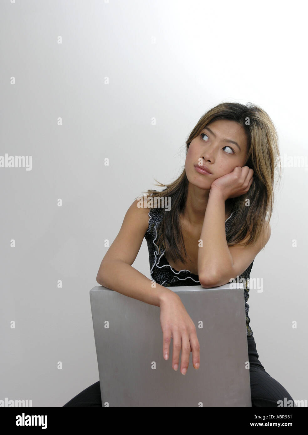 oriental woman sitting on chair Stock Photo