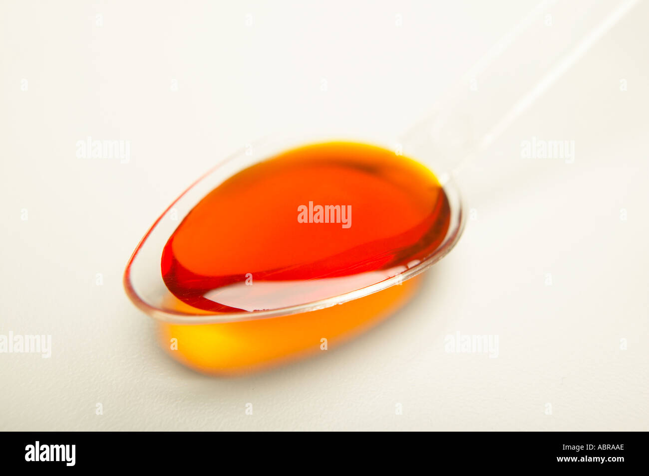 PLASTIC SPOON CONTAINING DOSE OF MEDICINE Stock Photo