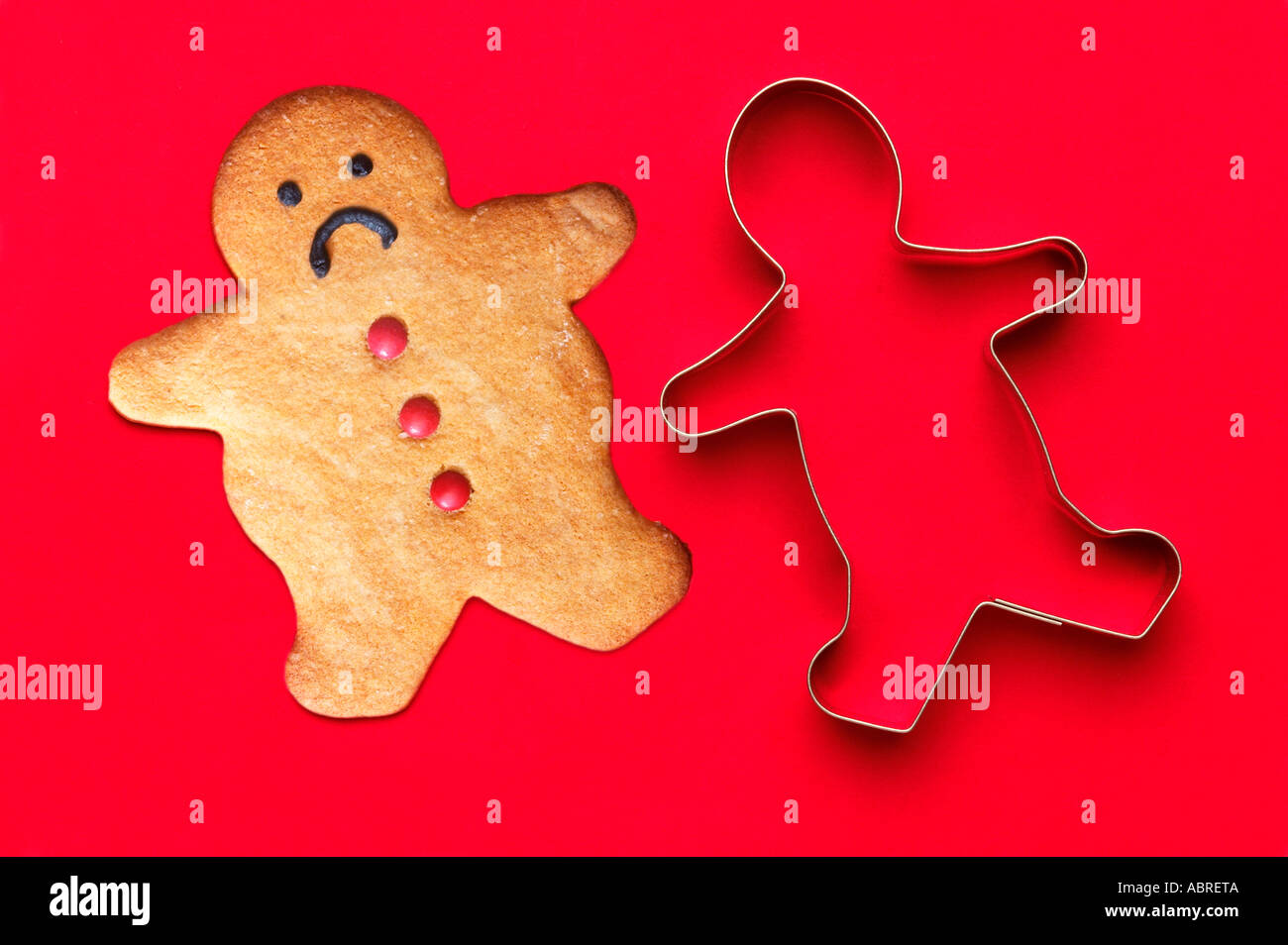 Ginger Statistics, Not Fitting The Mold. Gingerbread Man next To Cutter Stock Photo